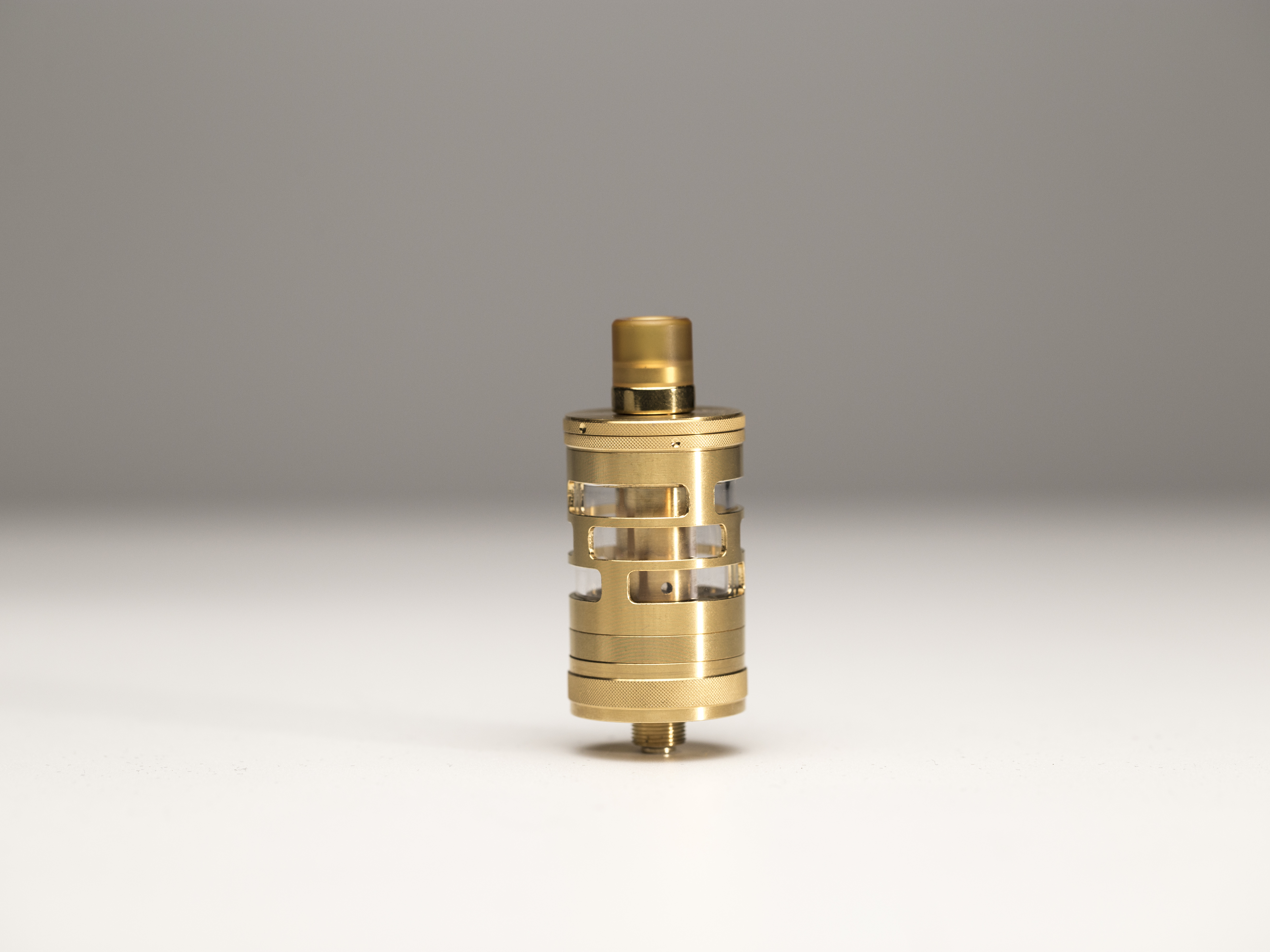The gold color version of the Aspire GT tank with its protective metal sleeve. 